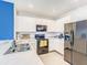 Modern kitchen with white cabinets, black appliances, and a stylish backsplash at 10024 Merry Fawn Ct, Sun City Center, FL 33573