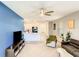 Open-concept living room with modern ceiling fan, plush carpet and an eat-in kitchen at 10024 Merry Fawn Ct, Sun City Center, FL 33573