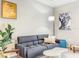 Stylish living room with gray sofa, white coffee table, contemporary art, and natural light at 10024 Merry Fawn Ct, Sun City Center, FL 33573