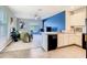 Bright living room with sliding glass doors, adjacent to kitchen featuring a scenic view at 10024 Merry Fawn Ct, Sun City Center, FL 33573