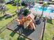 Community playground for residents surrounded by lounge chairs and a pool at 10024 Merry Fawn Ct, Sun City Center, FL 33573