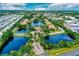 Drone shot featuring the community's residences, waterway, lush landscape, and private entrances at 10265 Gandy N Blvd # 1409, St Petersburg, FL 33702