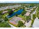 An aerial view of community tennis courts, parking, waterway, and residences at 10265 Gandy N Blvd # 1409, St Petersburg, FL 33702