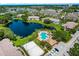 Aerial view of the community featuring a lake, swimming pool, sand volleyball court, and ample parking at 10265 Gandy N Blvd # 1409, St Petersburg, FL 33702