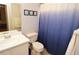 Bright bathroom featuring a blue shower curtain and a single sink at 10265 Gandy N Blvd # 1409, St Petersburg, FL 33702
