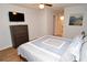 Comfortable bedroom with a ceiling fan and dark wood dresser. A bathroom doorway is visible at 10265 Gandy N Blvd # 1409, St Petersburg, FL 33702