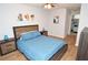 Bedroom features a bed with blue bedding, wood bedside tables, and artwork on the walls at 10265 Gandy N Blvd # 1409, St Petersburg, FL 33702