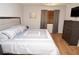 Spacious bedroom features plush bedding and a dark wood dresser with mounted television at 10265 Gandy N Blvd # 1409, St Petersburg, FL 33702