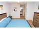 Bedroom with a queen bed, wooden dresser, and ensuite bathroom access at 10265 Gandy N Blvd # 1409, St Petersburg, FL 33702
