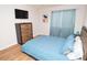 Bedroom with a queen bed, wooden dresser, and blue curtains at 10265 Gandy N Blvd # 1409, St Petersburg, FL 33702