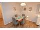 Bright dining area featuring modern frosted glass table and seating for four at 10265 Gandy N Blvd # 1409, St Petersburg, FL 33702