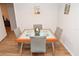 Bright dining area with seating for four and modern frosted glass table at 10265 Gandy N Blvd # 1409, St Petersburg, FL 33702