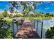 Dock on community lake with water fountain in background and landscaping at 10265 Gandy N Blvd # 1409, St Petersburg, FL 33702