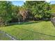 Community dog park surrounded by green trees and chain link fence. Includes signage and grass at 10265 Gandy N Blvd # 1409, St Petersburg, FL 33702