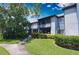 Exterior shot of a two story condo with well maintained lawn and sidewalk at 10265 Gandy N Blvd # 1409, St Petersburg, FL 33702