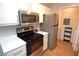 Well-lit kitchen with stainless steel appliances and white cabinets at 10265 Gandy N Blvd # 1409, St Petersburg, FL 33702