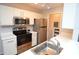 Well-lit kitchen with stainless steel appliances and white cabinets at 10265 Gandy N Blvd # 1409, St Petersburg, FL 33702