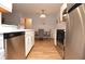 Modern kitchen featuring stainless steel appliances, white cabinets, and wood flooring at 10265 Gandy N Blvd # 1409, St Petersburg, FL 33702