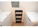 Bright laundry room with stacked washer and dryer and modern storage rack at 10265 Gandy N Blvd # 1409, St Petersburg, FL 33702