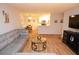 Open-concept living room with wood floors, couch, coffee table, and view to kitchen at 10265 Gandy N Blvd # 1409, St Petersburg, FL 33702