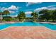 Community pool with a waterfall feature surrounded by lush greenery and palm trees at 10265 Gandy N Blvd # 1409, St Petersburg, FL 33702