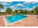 Community pool with shallow entry and deck chairs at 10265 Gandy N Blvd # 1409, St Petersburg, FL 33702