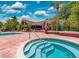 Community pool with a hot tub and red brick patio, perfect for relaxation at 10265 Gandy N Blvd # 1409, St Petersburg, FL 33702