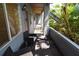 View of the unit's porch with two chairs and foliage at 10265 Gandy N Blvd # 1409, St Petersburg, FL 33702