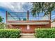Exterior view of the community racquetball court with roof and landscaping at 10265 Gandy N Blvd # 1409, St Petersburg, FL 33702