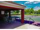 Exterior community tennis courts with shade shelter and seating overlooking the waterway at 10265 Gandy N Blvd # 1409, St Petersburg, FL 33702