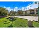 Community sand volleyball court next to picnic area with tables and barbecue under a sunny sky at 10265 Gandy N Blvd # 1409, St Petersburg, FL 33702