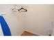 Walk-in closet features wood-look tile flooring, white wire shelving, and ironing board at 10265 Gandy N Blvd # 1409, St Petersburg, FL 33702