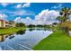 Picturesque waterfront view of the condo community with lush green lawns and reflective water at 10265 Gandy N Blvd # 1409, St Petersburg, FL 33702