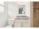 Bathroom featuring tiled shower, modern vanity with gray counter and white cabinet, and modern fixtures at 10336 Alice M Ct, Port Richey, FL 34668