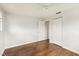 Bedroom featuring hardwood floors, fresh white walls, and two closets at 10336 Alice M Ct, Port Richey, FL 34668