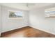 Bedroom featuring hardwood floors, white walls, a ceiling fan, and lots of natural light at 10336 Alice M Ct, Port Richey, FL 34668