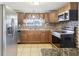 Well-lit kitchen featuring stainless steel appliances, granite countertops, and tiled backsplash at 10336 Alice M Ct, Port Richey, FL 34668