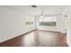 Inviting living room with hardwood floors, large windows, and a ceiling fan at 10336 Alice M Ct, Port Richey, FL 34668