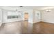 Open living area with hardwood floors and an abundance of natural light at 10336 Alice M Ct, Port Richey, FL 34668