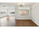 Bright living room with hardwood floors, windows overlooking the backyard, and modern lighting at 10336 Alice M Ct, Port Richey, FL 34668