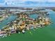 Wide aerial view captures waterfront neighborhood with houses, boat docks, and tranquil green waters at 1135 81St S St, St Petersburg, FL 33707