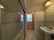 Bathroom featuring a glass-enclosed shower, sink, and a large mirror, perfect for your comfort and convenience at 1135 81St S St, St Petersburg, FL 33707