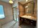 Functional bathroom featuring a tiled shower, vanity with storage, and a well-lit mirror at 1135 81St S St, St Petersburg, FL 33707