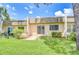 Charming backyard patio with lush green grass and beautiful landscaping at 11511 113Th St # 33D, Largo, FL 33778