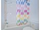 Bathroom features a shower-tub combination, a tile surround, and white fixtures at 11511 113Th St # 33D, Largo, FL 33778