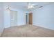 Cozy bedroom featuring neutral carpet, ceiling fan, and closet, bathed in soft, natural light at 11511 113Th St # 33D, Largo, FL 33778