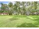 Lush green lawn area surrounded by mature trees offering beautiful views in a serene setting at 11511 113Th St # 33D, Largo, FL 33778