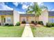 Charming home exterior featuring a well-manicured lawn, walkway, and a beautiful palm tree at 11511 113Th St # 33D, Largo, FL 33778