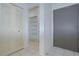 Hallway with white closet doors, a pantry with shelves, and tile flooring at 11511 113Th St # 33D, Largo, FL 33778