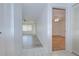 Bright hallway features tiled flooring and leads to the carpeted bedroom with a ceiling fan at 11511 113Th St # 33D, Largo, FL 33778